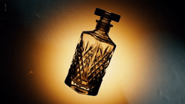 a glass bottle that is sitting on a table