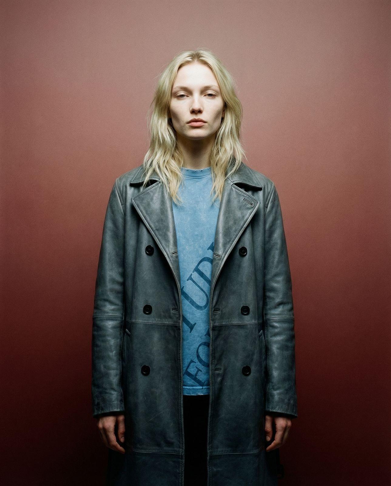 a woman standing in front of a red wall