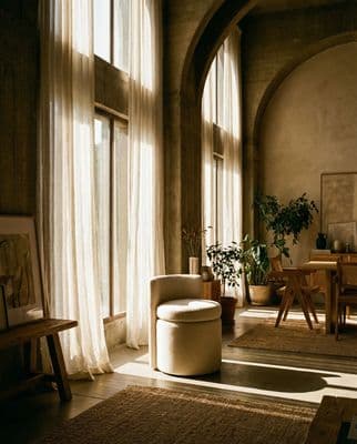 a living room filled with furniture and large windows