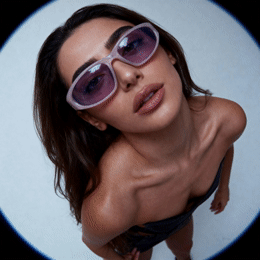 a woman in a bathing suit and sunglasses
