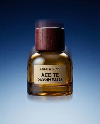 a bottle of aceite sagrado on a blue background
