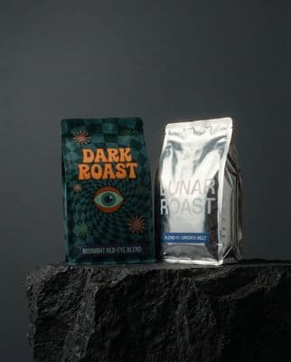 a bag of coffee sitting on top of a rock