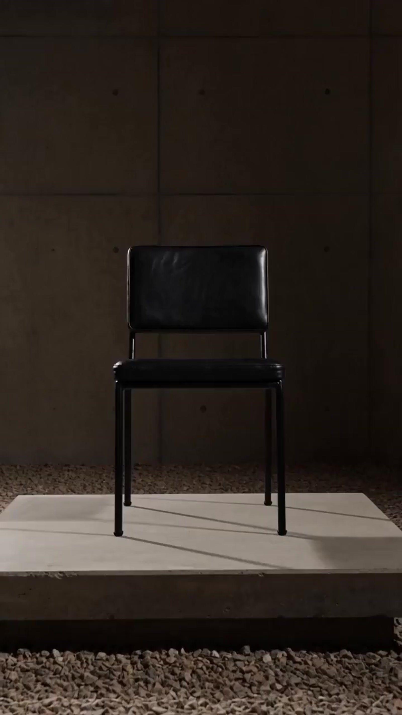 a black chair sitting on top of a white platform
