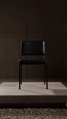 a black chair sitting on top of a white platform