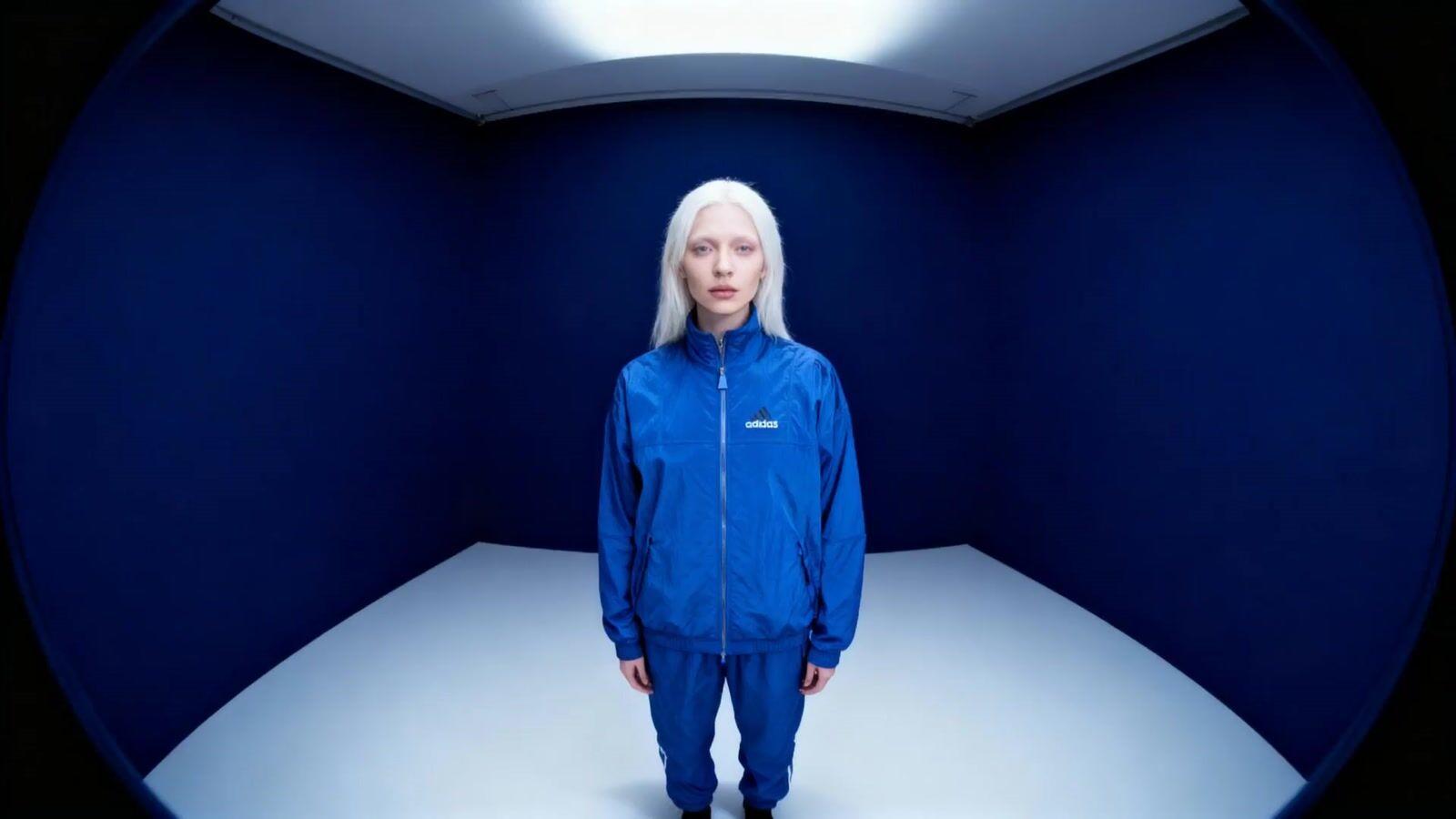 a woman with white hair standing in a room