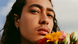 a close up of a person holding a flower