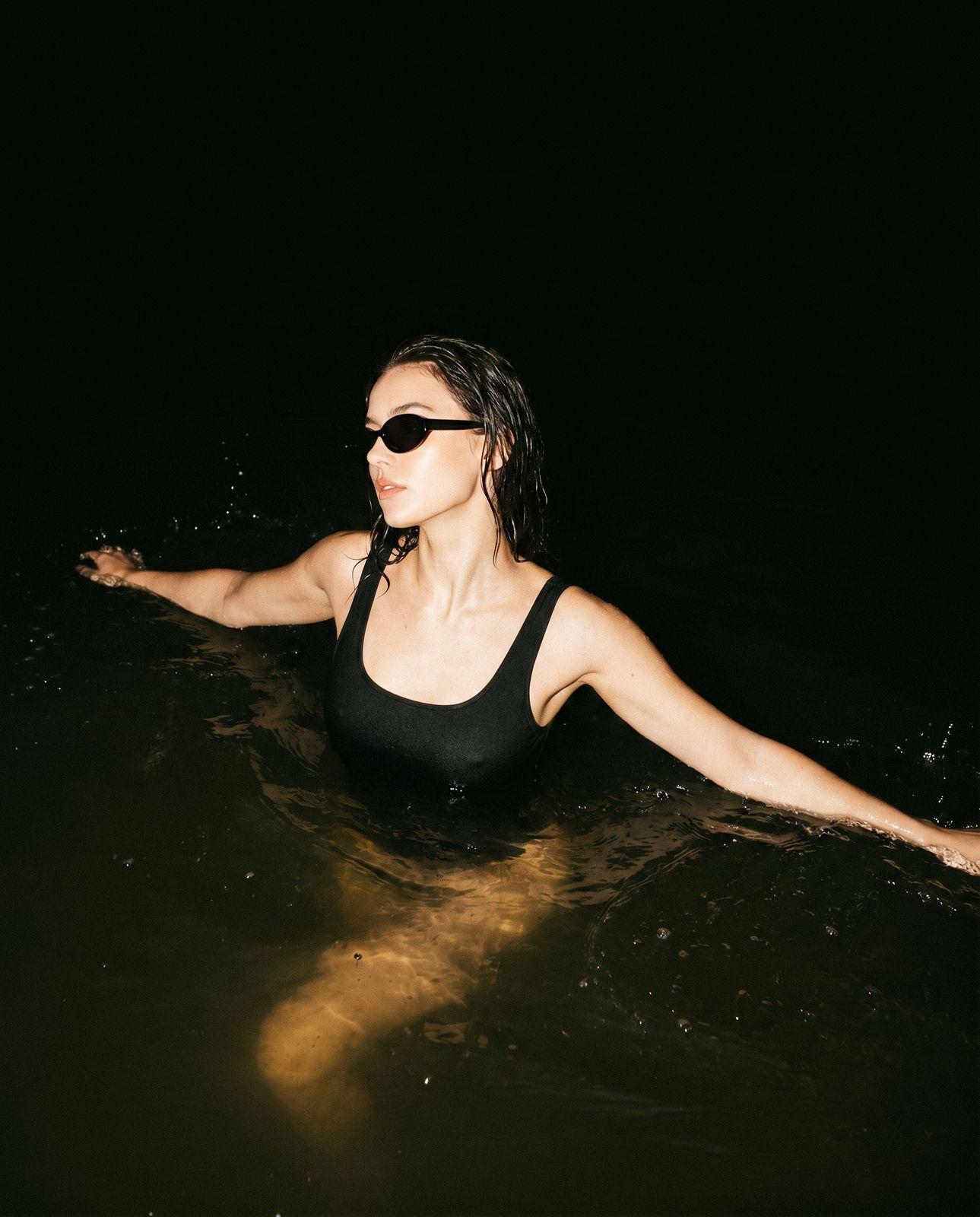 a woman in a black bathing suit in the water