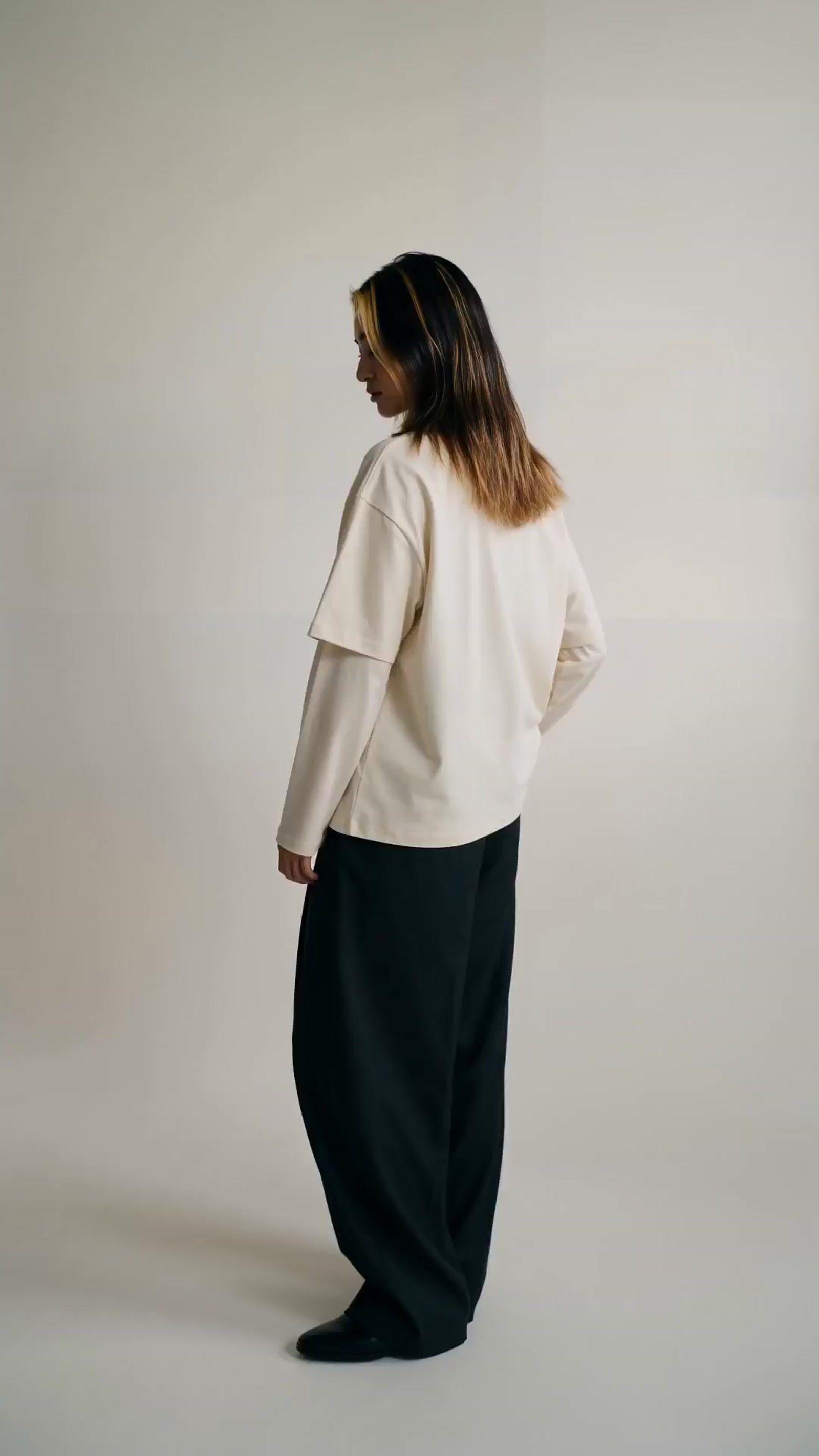 a woman in a white shirt and black pants