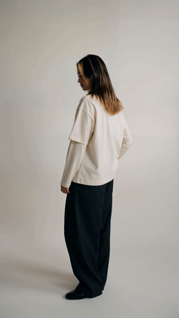 a woman in a white shirt and black pants