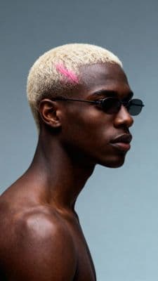 a man with a pink mohawk and sunglasses