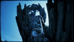 a close up of a statue of a bird on a tree