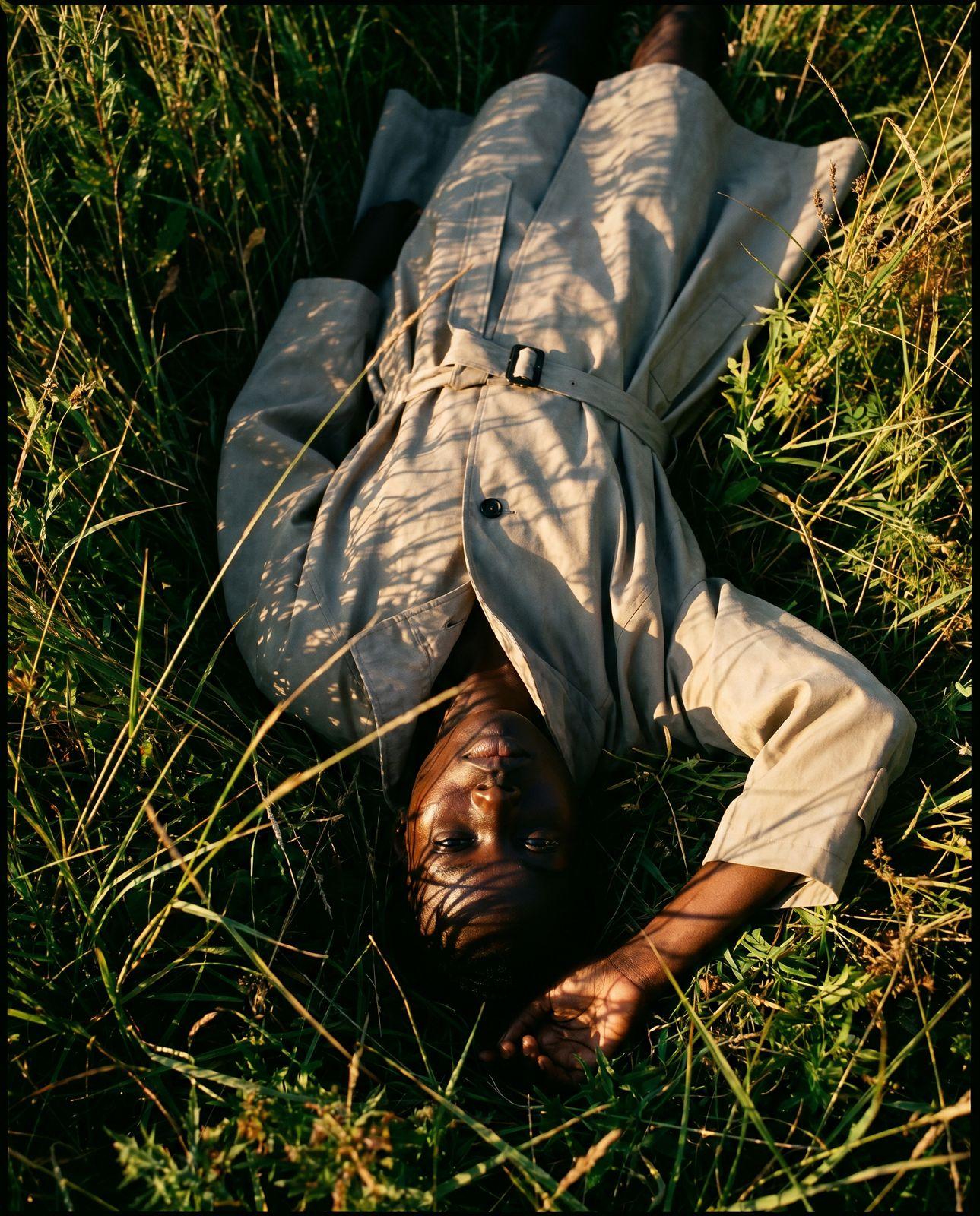 a person laying on the ground in the grass