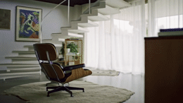 a chair sitting on top of a rug in a living room