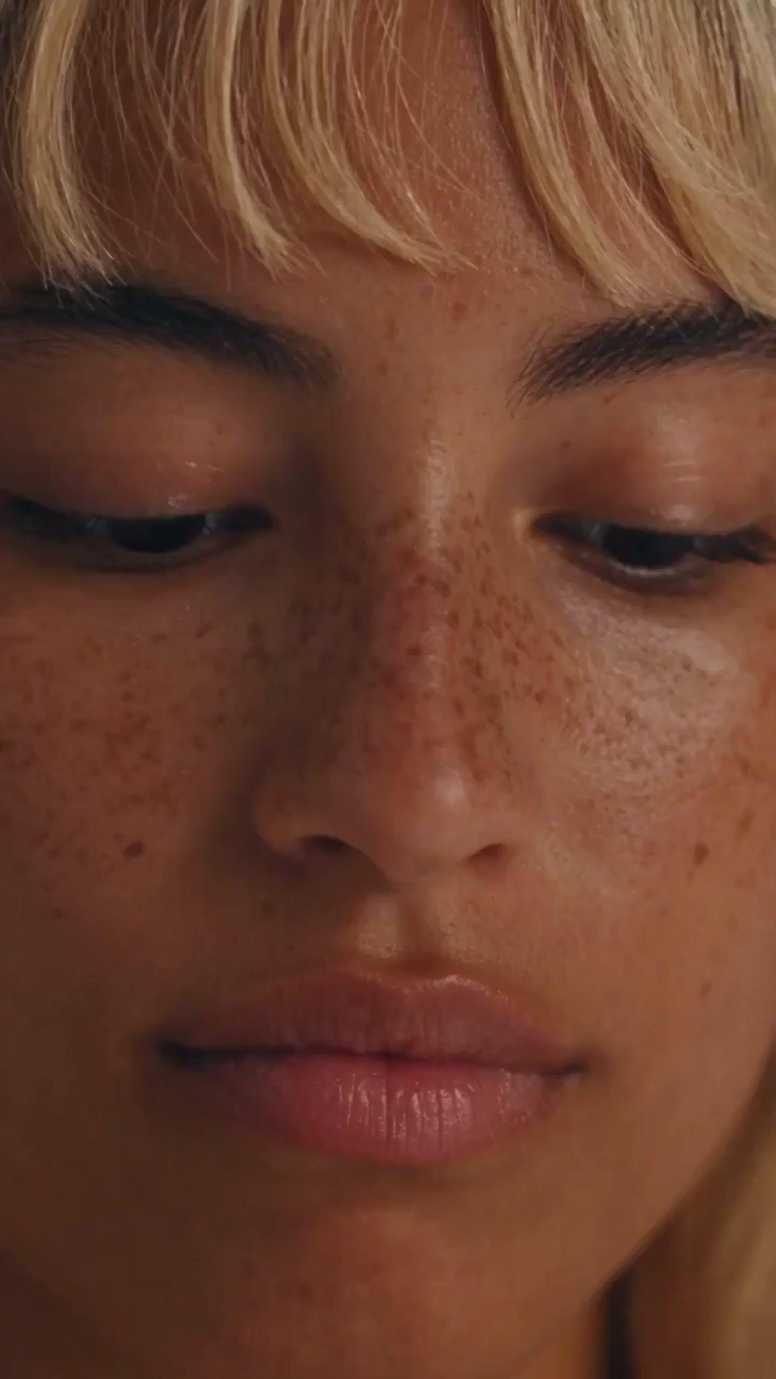 a close up of a woman with freckles on her face