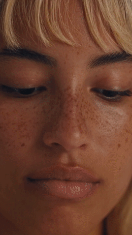 a close up of a woman with freckles on her face