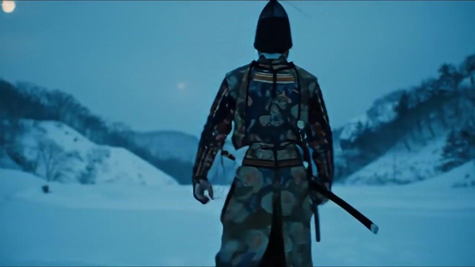 a man with a sword standing in the snow