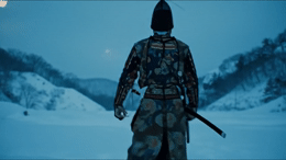 a man with a sword standing in the snow