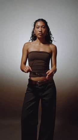 a woman in a strapless top poses for a picture