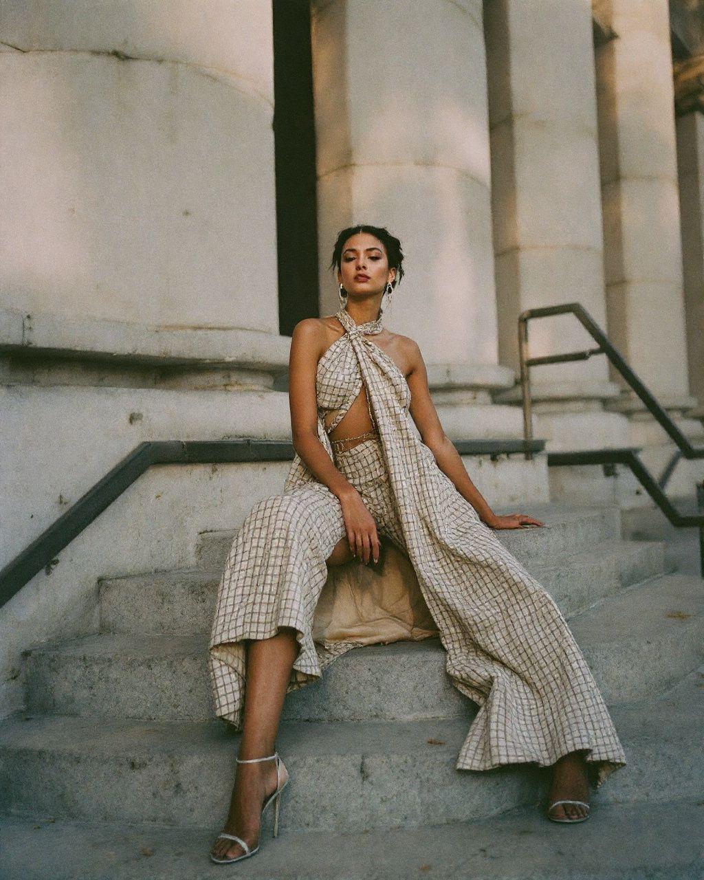 a woman is sitting on the steps of a building