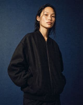 a woman standing in front of a blue background