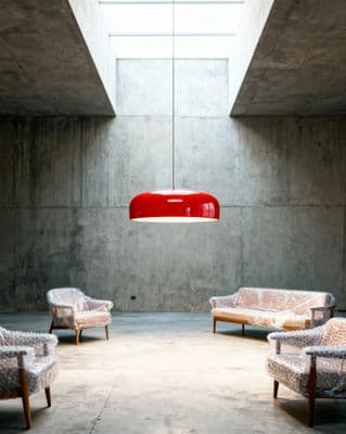 a room with several chairs and a lamp