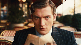 a man in a suit and tie sitting at a table