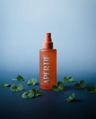 a bottle of argan oil on a blue background