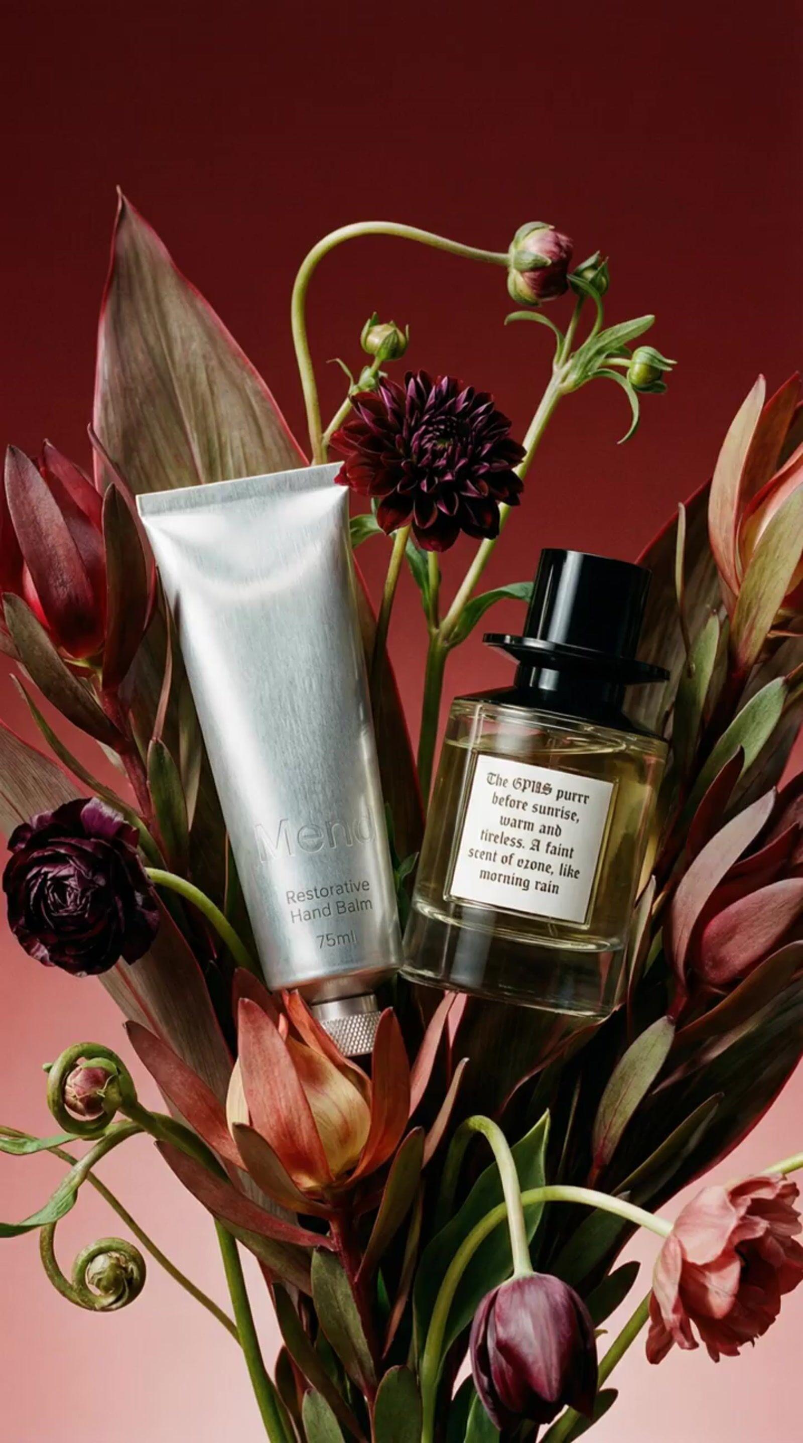 a vase filled with flowers and a bottle of perfume