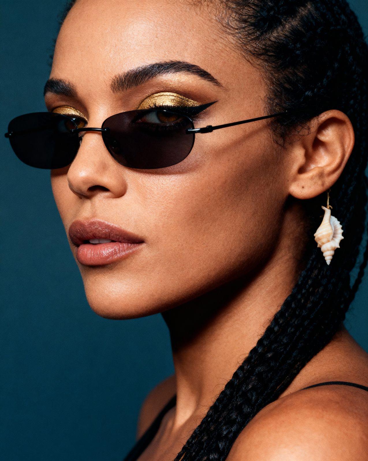 a woman wearing a pair of black sunglasses