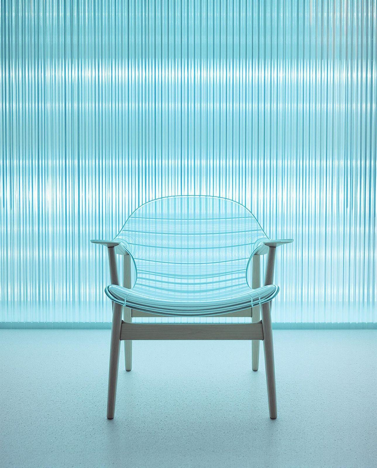 a blue chair sitting in front of a window