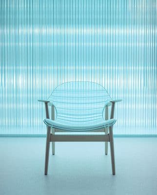 a blue chair sitting in front of a window