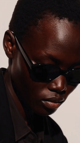 a man wearing sunglasses and a black shirt