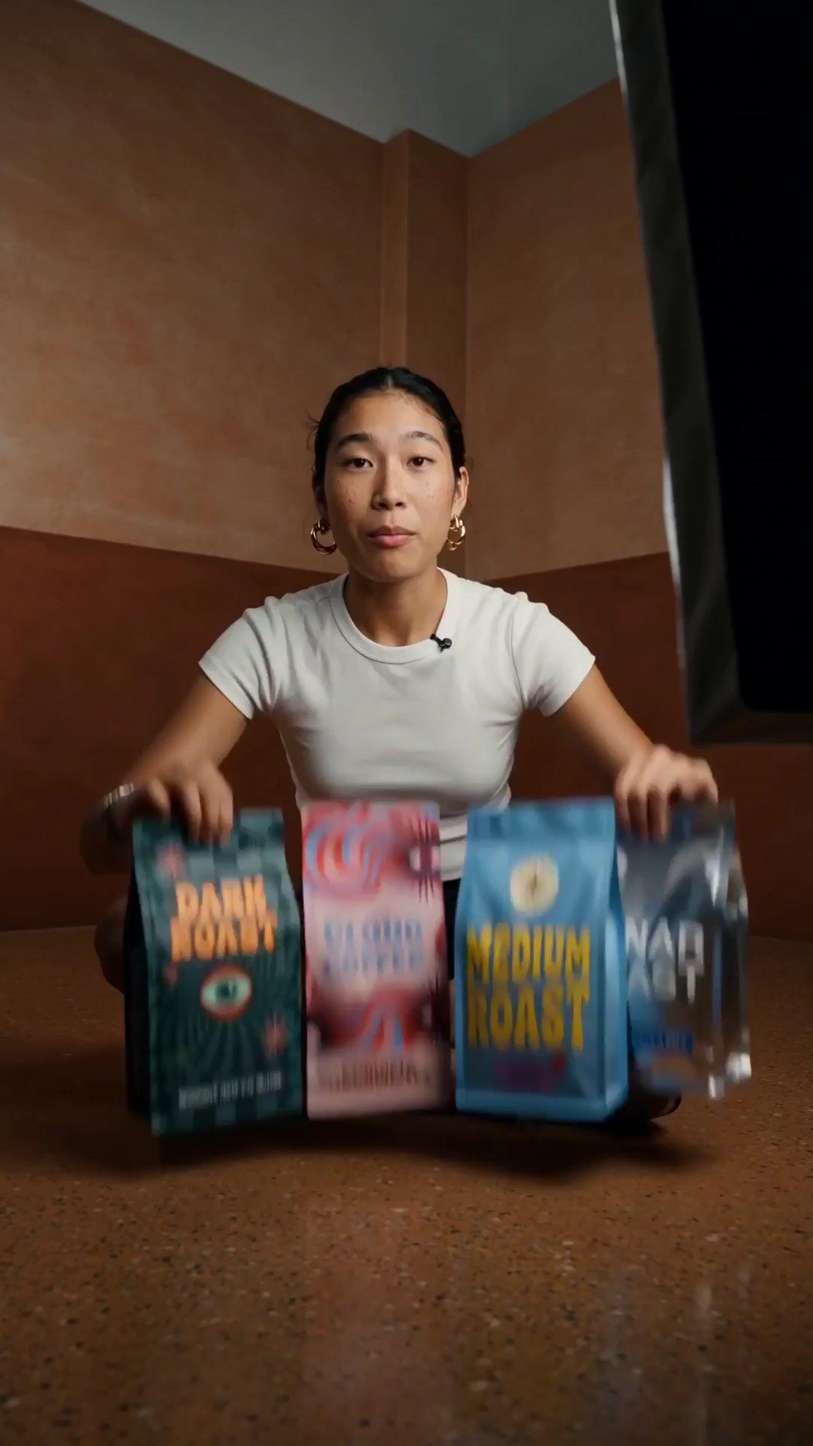 a woman sitting on the floor holding three bags of food