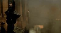 a man standing in a room with a black mask on