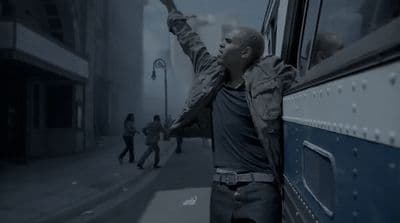 a man leaning out the window of a bus