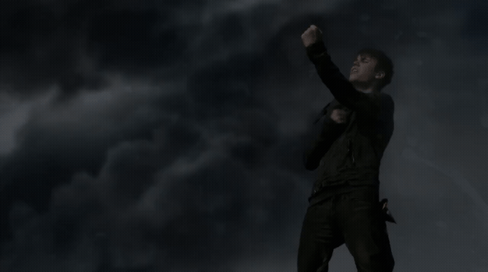 a man standing on top of a roof under a cloudy sky