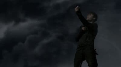 a man standing on top of a roof under a cloudy sky