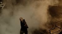 a man standing in the middle of a cloud of smoke