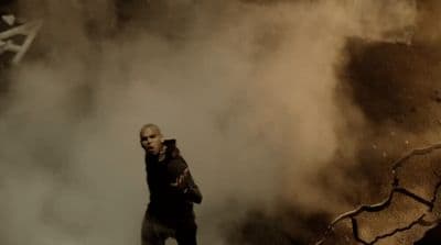 a man standing in the middle of a cloud of smoke