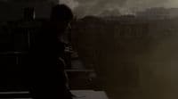 a person standing on a roof with smoke coming out of the sky