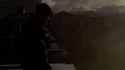 a person standing on a roof with smoke coming out of the sky