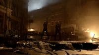 a group of people standing on a street next to a fire