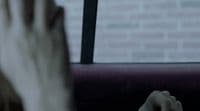 a woman sitting on a bus looking out the window