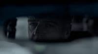 a man looking out the window of a car