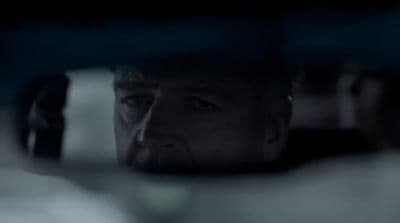 a man looking out the window of a car