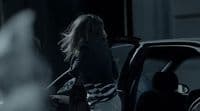 a woman getting out of a car at night