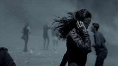 a woman talking on a cell phone in a foggy area