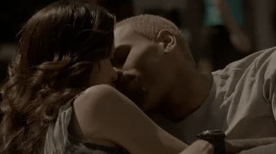 a man kissing a woman on the cheek
