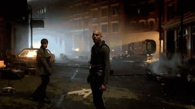 a couple of men standing next to each other on a street