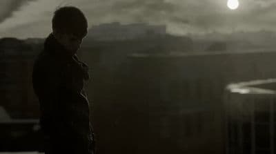 a man standing in front of a city skyline